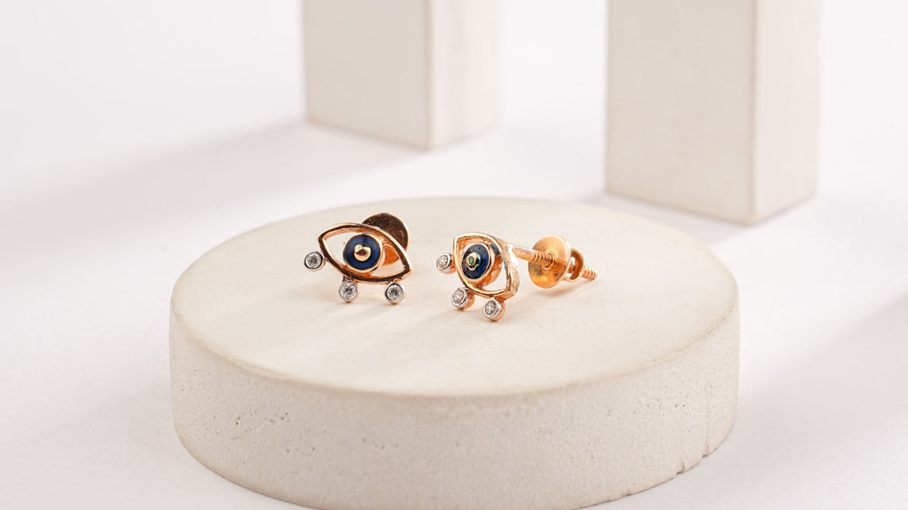 Pair of earrings on a white stand with a light gray background