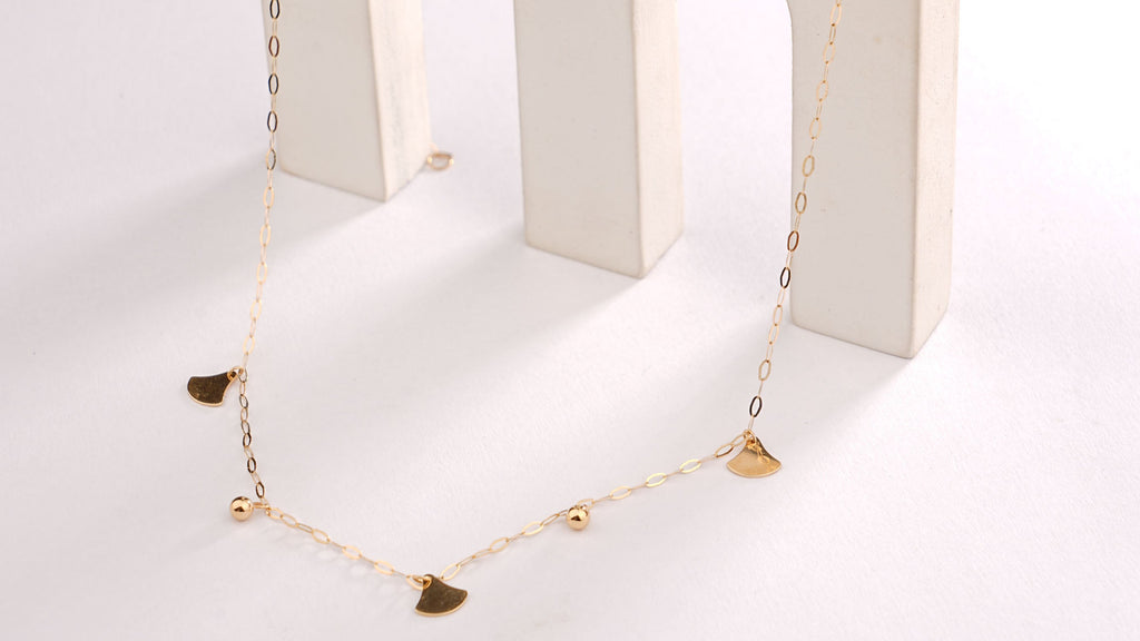 Necklace displayed in a white jewelry box on a light gray background