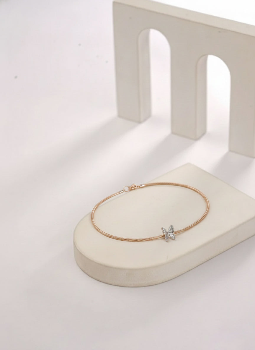 Gold necklace with a star pendant on a white stand